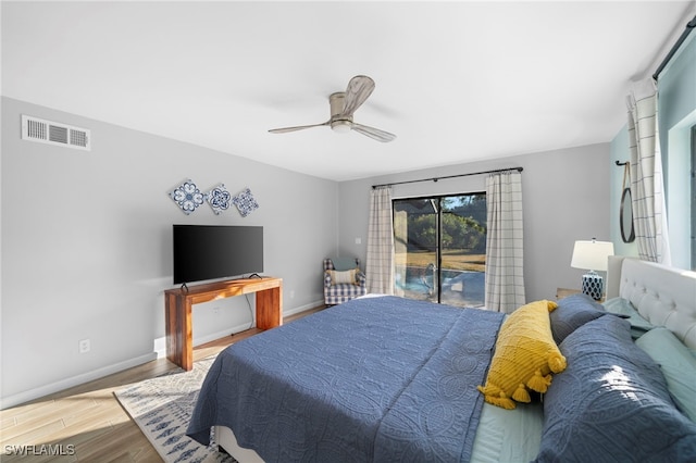 bedroom with access to outside, a ceiling fan, baseboards, wood finished floors, and visible vents