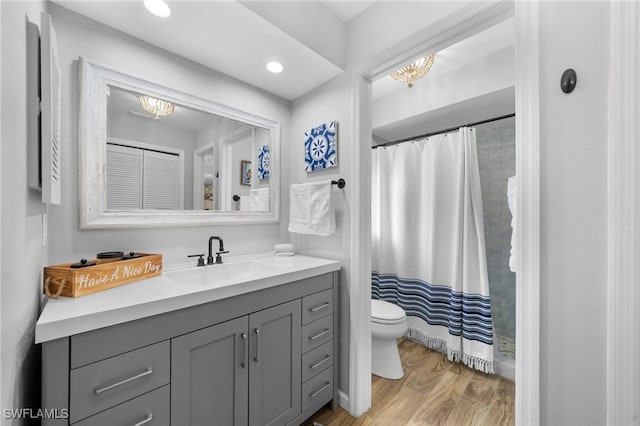 bathroom with vanity, a shower with shower curtain, toilet, and a notable chandelier