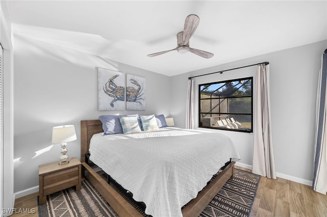 bedroom with ceiling fan and light hardwood / wood-style floors