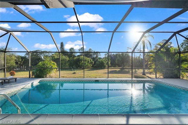 view of swimming pool with a lanai and a patio area