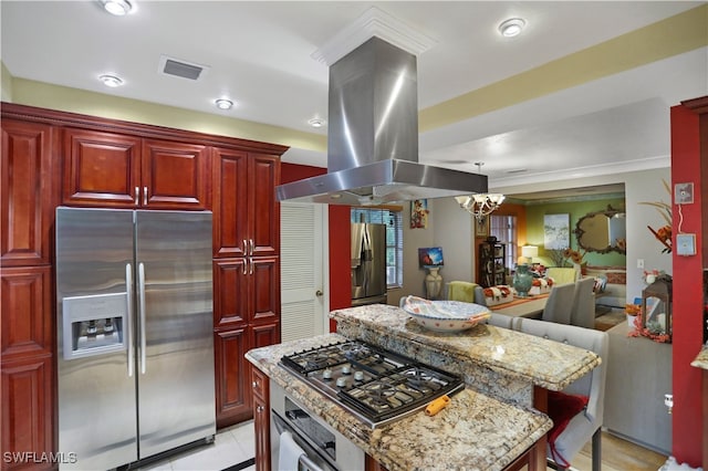 kitchen featuring appliances with stainless steel finishes, island exhaust hood, a center island, a kitchen breakfast bar, and light stone counters