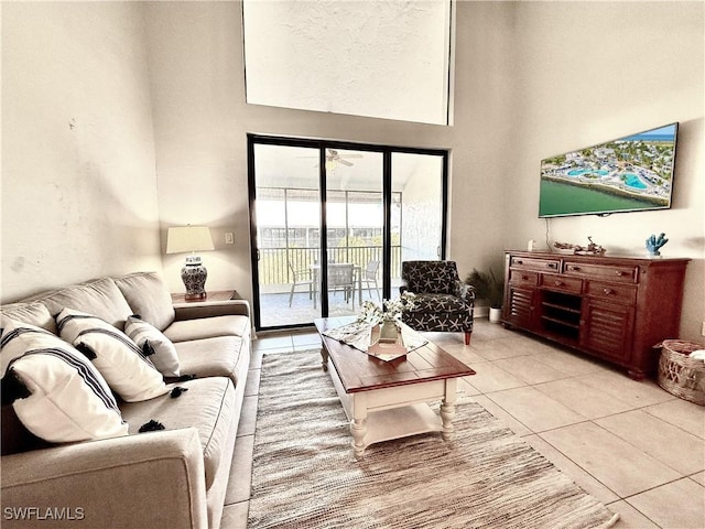 living area featuring a high ceiling and light tile patterned floors