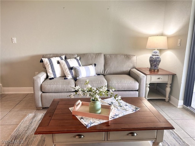 living room featuring light tile patterned flooring and baseboards