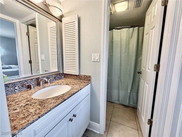 full bath with visible vents, vanity, and tile patterned floors