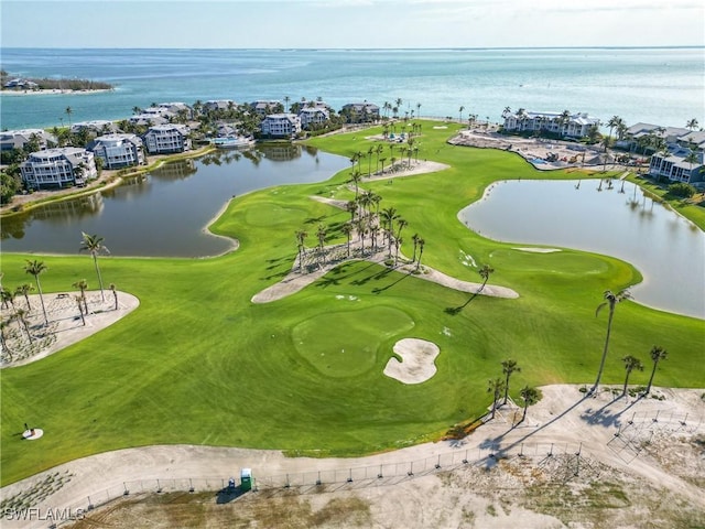 bird's eye view featuring view of golf course and a water view