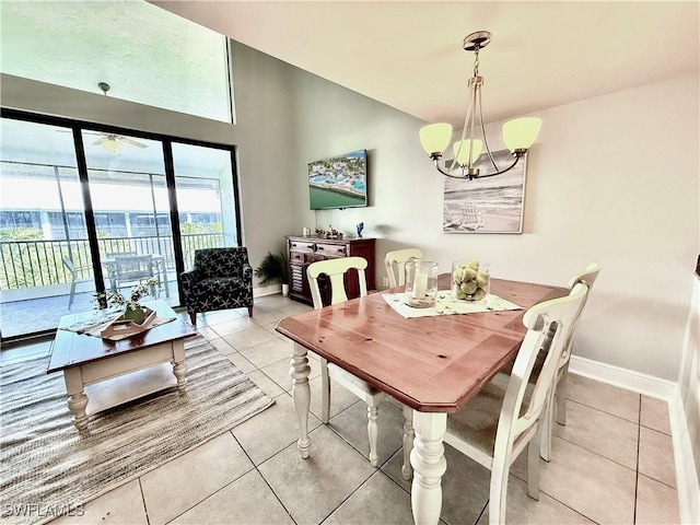 dining area featuring light tile patterned floors, baseboards, and an inviting chandelier