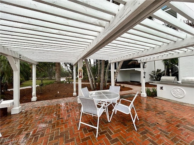 view of patio / terrace with exterior kitchen, outdoor dining space, and a pergola