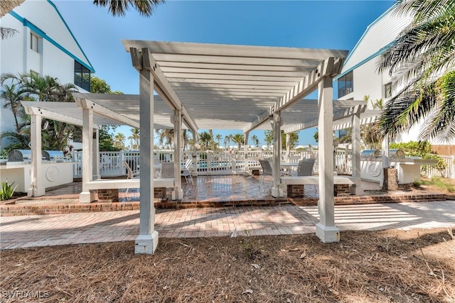 view of patio with fence, a pergola, and area for grilling