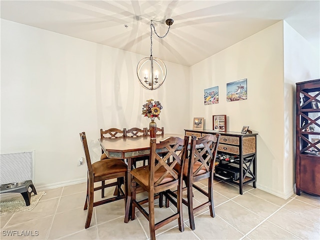 tiled dining room featuring an inviting chandelier