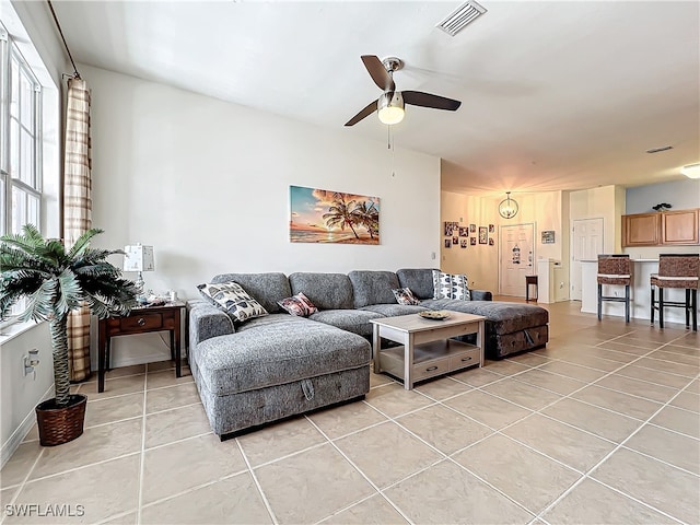 living room featuring ceiling fan and light tile patterned floors