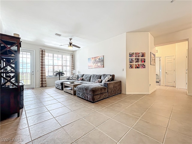 tiled living room with ceiling fan