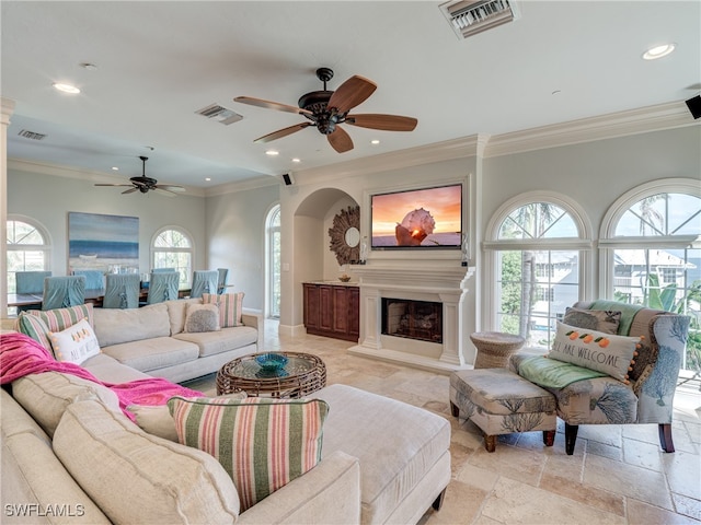 living room with ornamental molding and ceiling fan