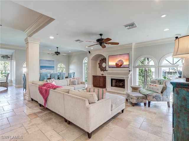 living room with ornamental molding, decorative columns, and ceiling fan