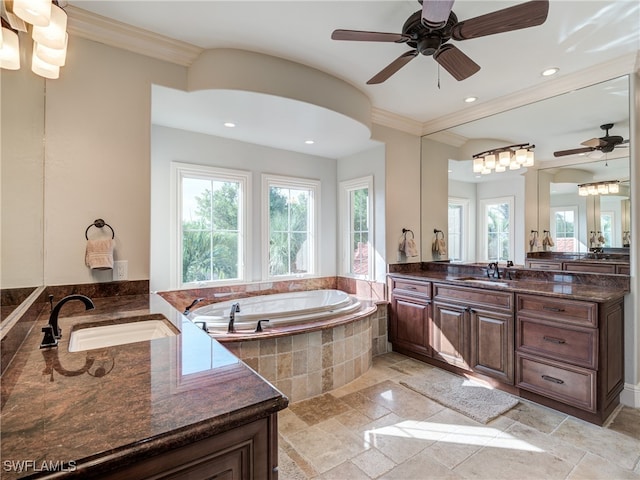 bathroom featuring vanity, tiled bath, crown molding, and ceiling fan