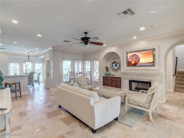 living room featuring crown molding and ceiling fan