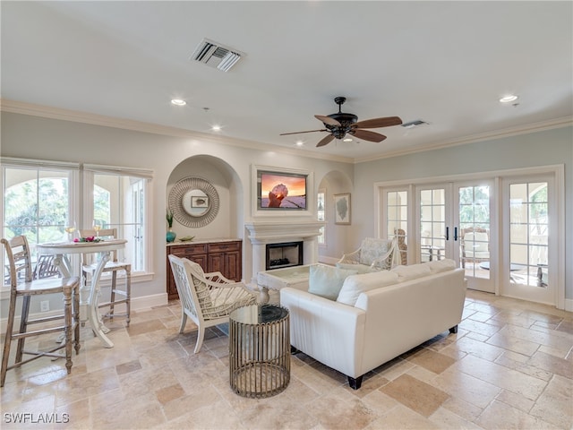 living room with french doors, ceiling fan, a healthy amount of sunlight, and ornamental molding