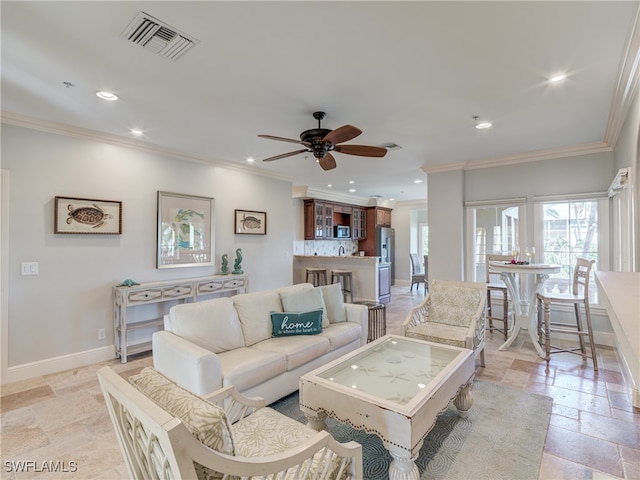 living room featuring ornamental molding and ceiling fan