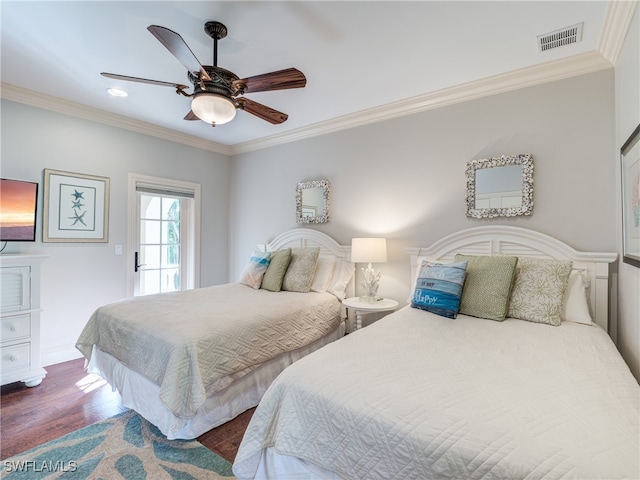 bedroom featuring dark wood-type flooring, crown molding, and ceiling fan