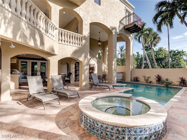 view of pool featuring an in ground hot tub, a patio, and french doors