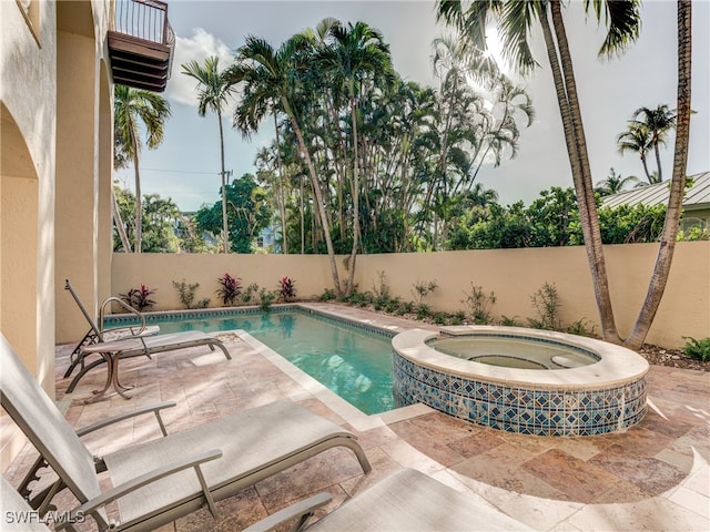 view of swimming pool with an in ground hot tub and a patio