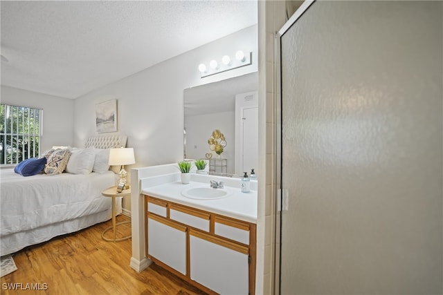 bedroom featuring sink and light hardwood / wood-style flooring