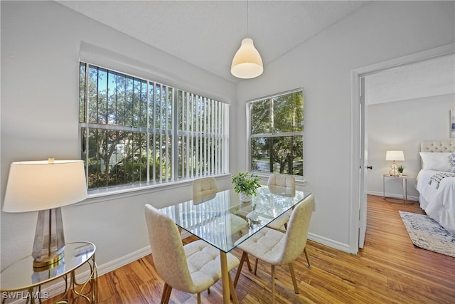 dining room featuring a textured ceiling and light hardwood / wood-style floors