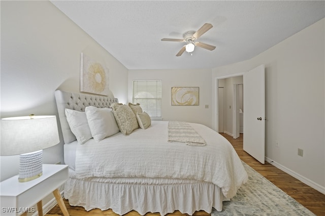 bedroom with ceiling fan and hardwood / wood-style floors