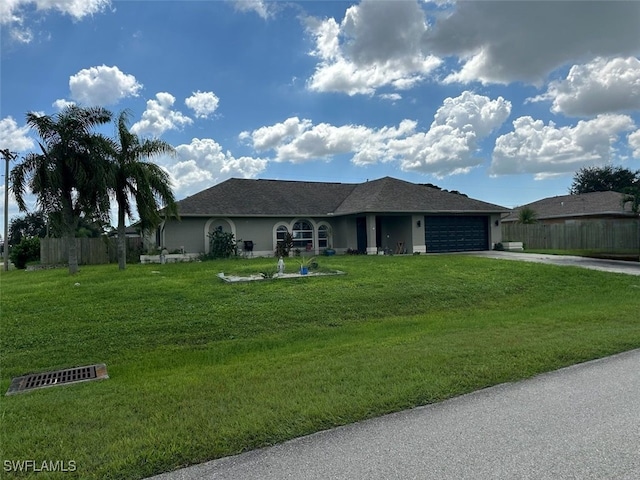 view of front of property featuring a front yard and a garage