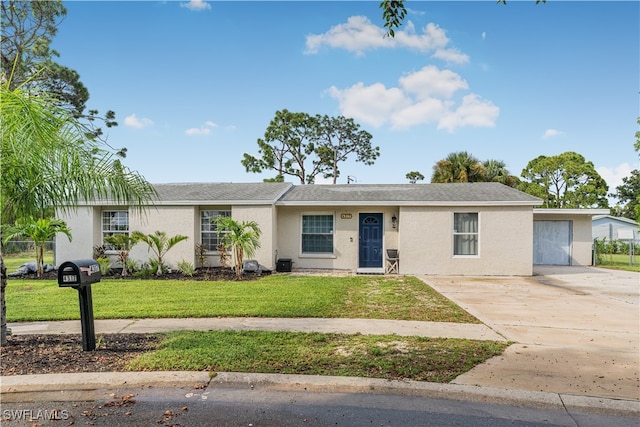 single story home featuring a garage and a front lawn