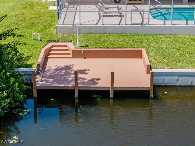 view of dock featuring a yard and a water view