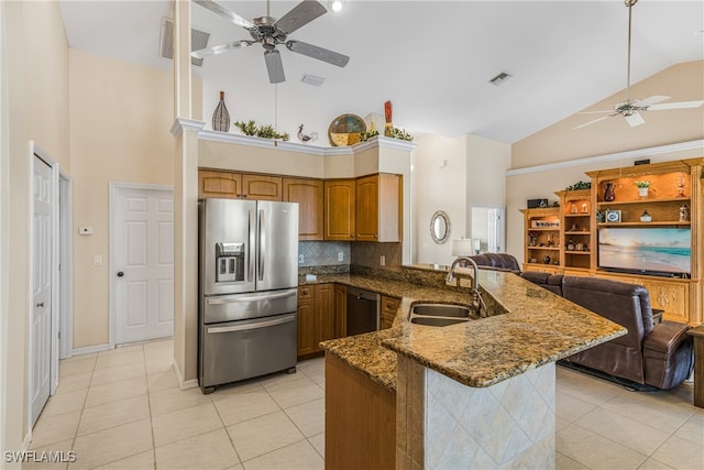 kitchen featuring light tile patterned floors, sink, kitchen peninsula, high vaulted ceiling, and appliances with stainless steel finishes