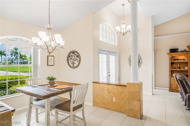 tiled dining area featuring lofted ceiling, french doors, and a chandelier