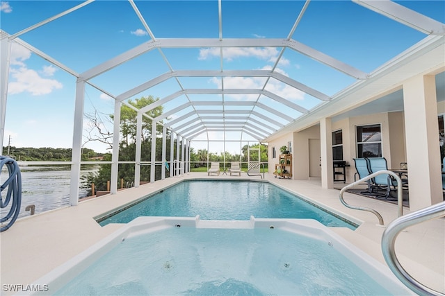 view of swimming pool with glass enclosure and a patio area