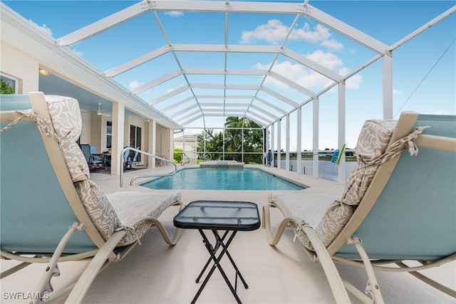 view of swimming pool featuring a patio and glass enclosure