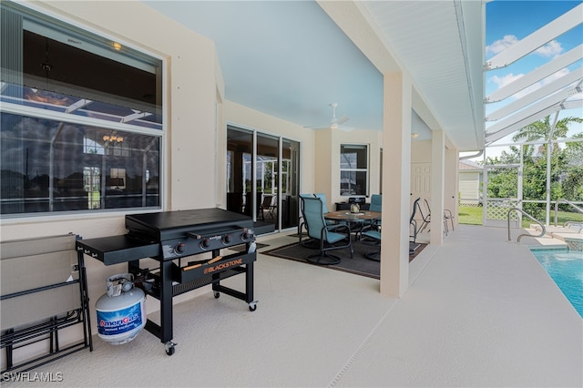 view of patio featuring ceiling fan and a lanai