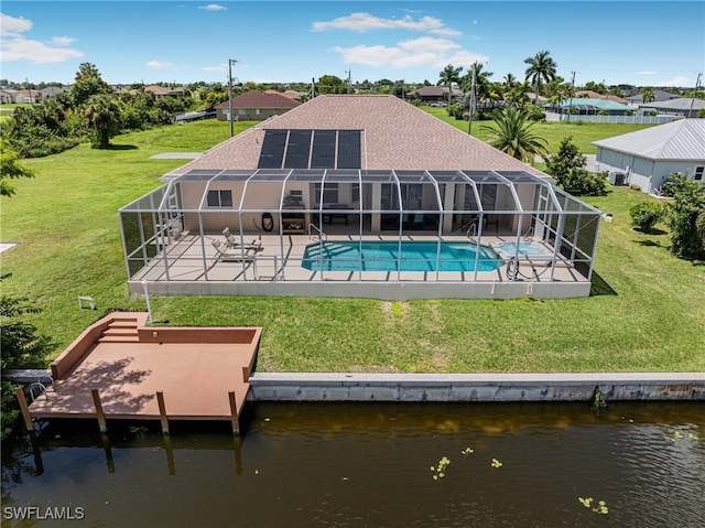 rear view of property with a lanai, a water view, a yard, and a patio area