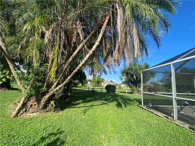 view of yard with glass enclosure