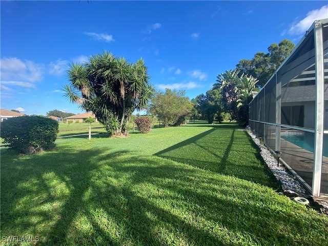 view of yard featuring glass enclosure