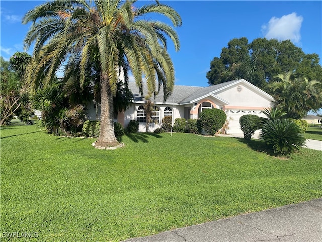 view of front of property featuring a front lawn and a garage