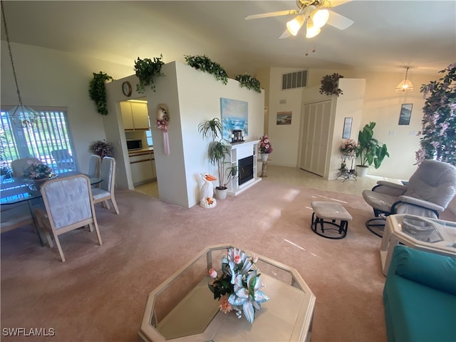 carpeted living room featuring lofted ceiling and ceiling fan