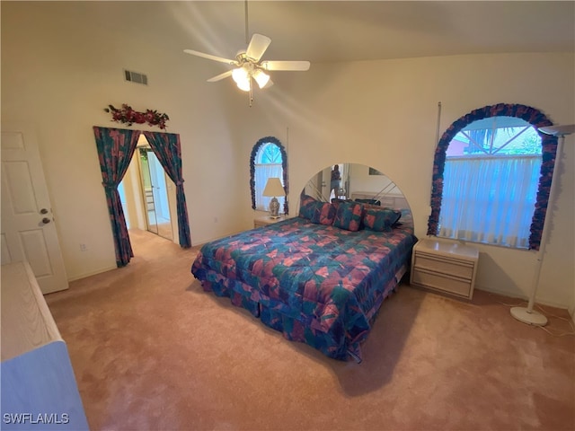 carpeted bedroom featuring a high ceiling and ceiling fan