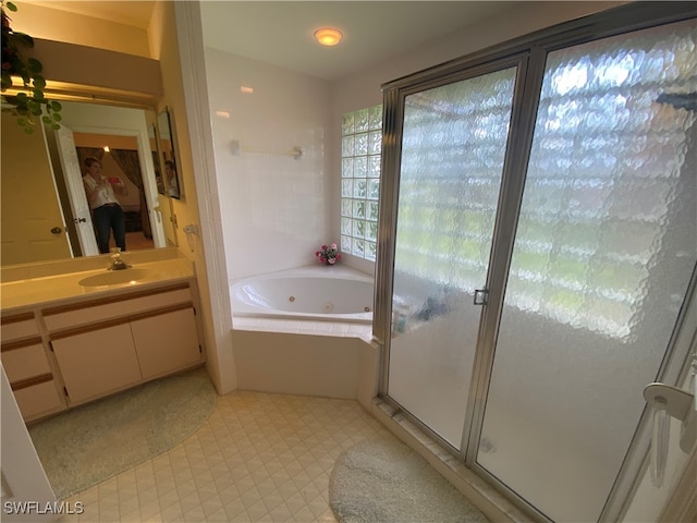 bathroom with vanity and separate shower and tub