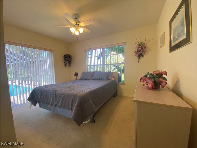 bedroom featuring ceiling fan, light colored carpet, and access to exterior