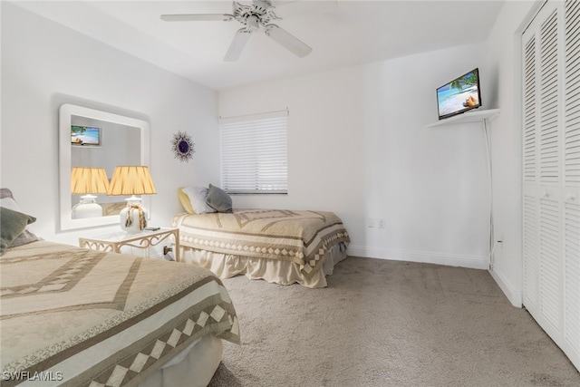 carpeted bedroom featuring a closet and ceiling fan