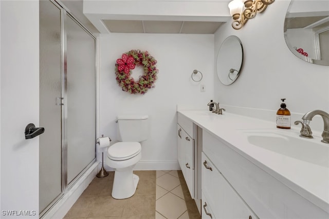 bathroom with toilet, vanity, walk in shower, and tile patterned flooring