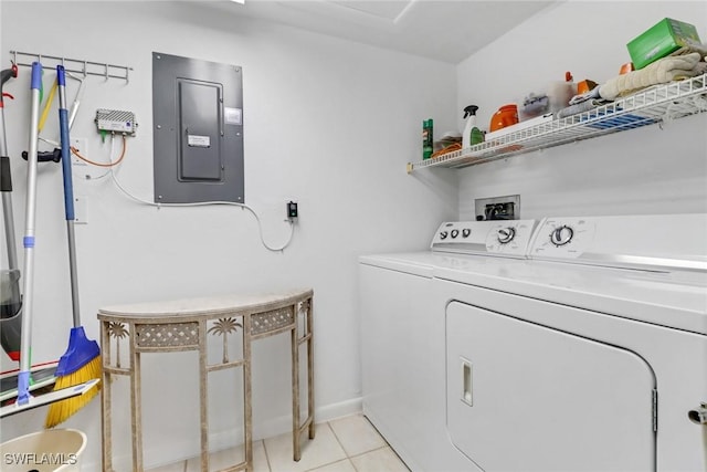 laundry room featuring light tile patterned floors, electric panel, and washer and clothes dryer