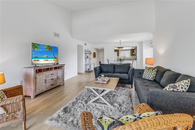 4600 Flagship Dr Unit 201, Fort Myers, FL 33919 - living room with a high ceiling, light wood finished floors, and visible vents
