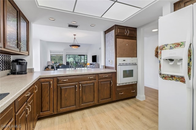 4600 Flagship Dr Unit 201, Fort Myers, FL 33919 - kitchen featuring hanging light fixtures, white appliances, light countertops, light wood-style flooring, and visible vents