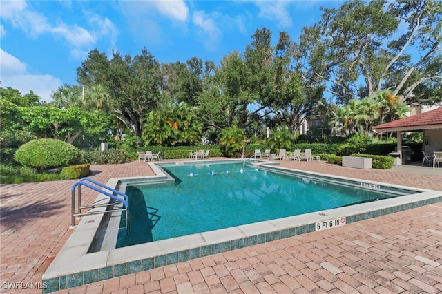 view of swimming pool featuring a patio area