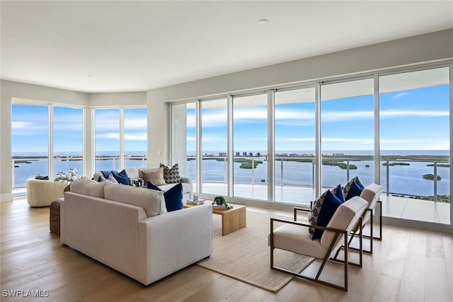 living room with wood-type flooring and a water view